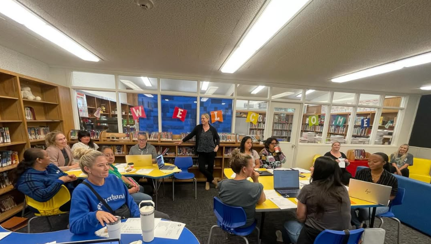 A group of past McPherson PTSA volunteers meeting in the school library